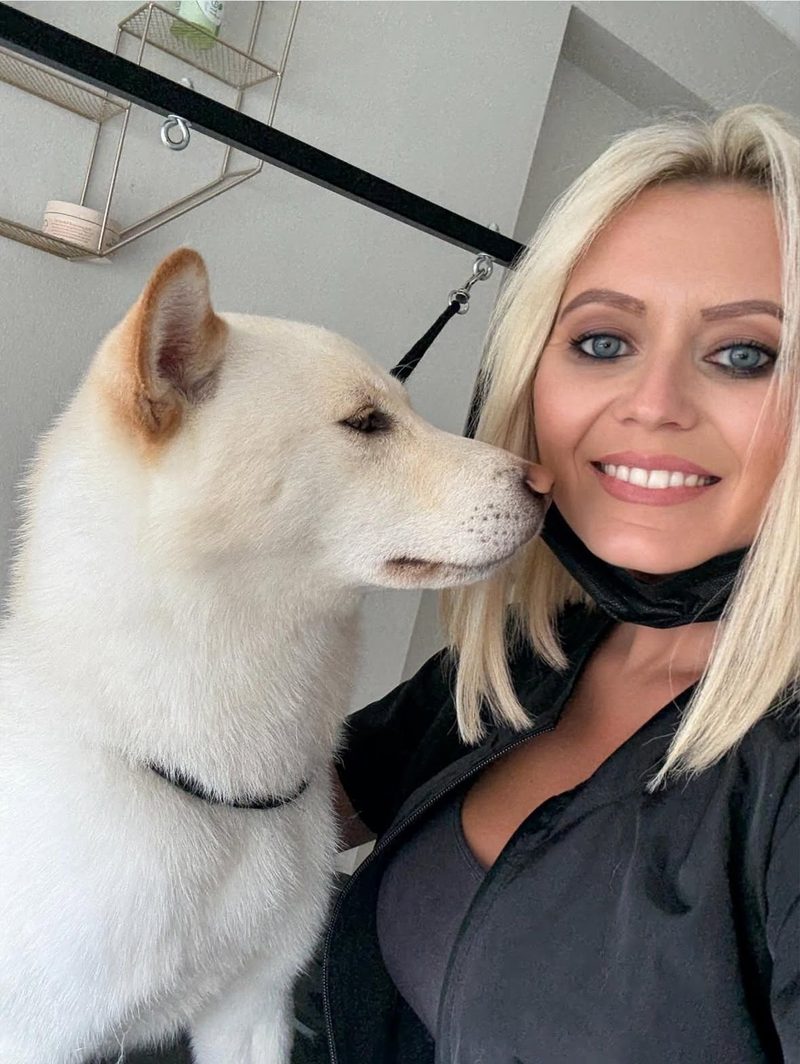 Michelle carefully grooming a dog in our boutique home salon